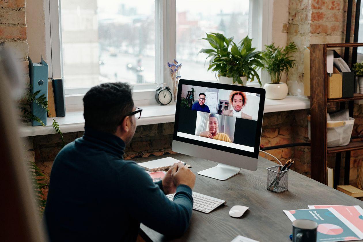 Professional on a video call with advisors from abroad